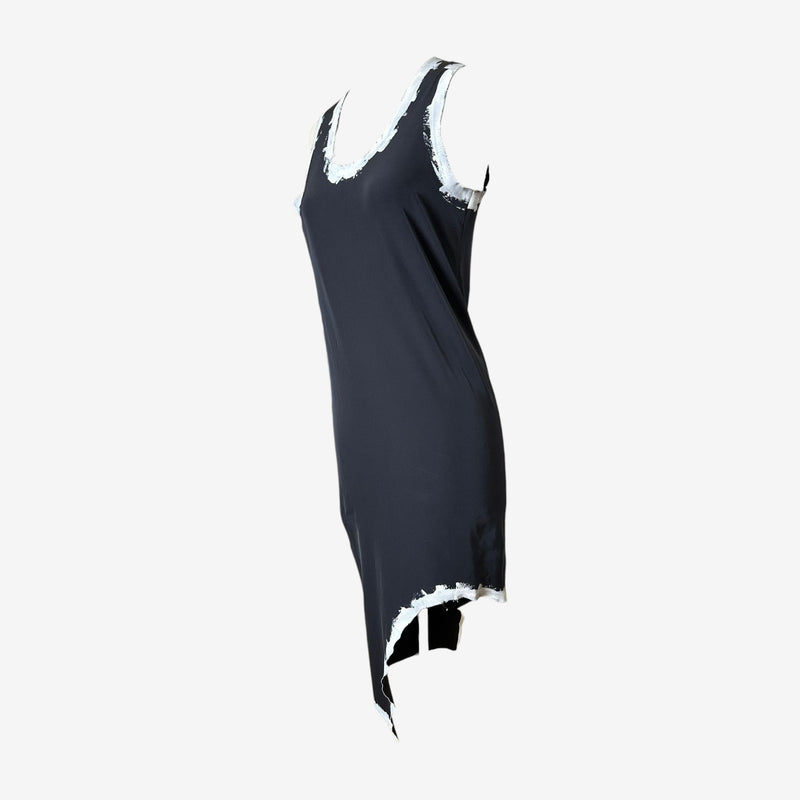 Close-up detail of hand-painted white brushstrokes on black jersey dress by Comme des Garçons