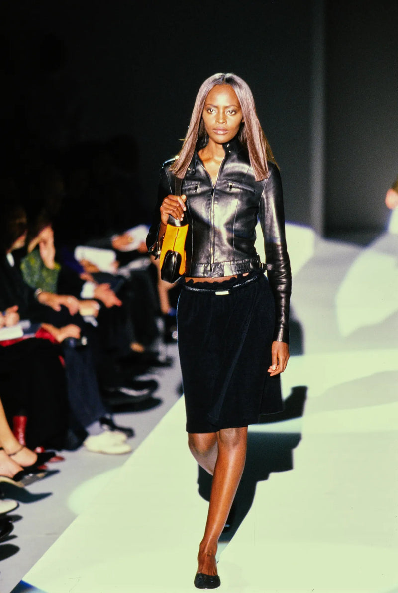 Gucci Spring/Summer 1999 runway presentation featuring black moto jacket design