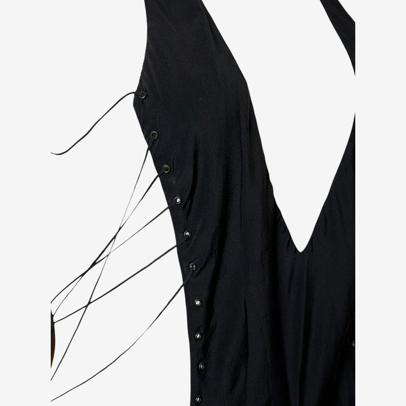 Detail of lace-up side panel with gunmetal eyelets on black silk gown