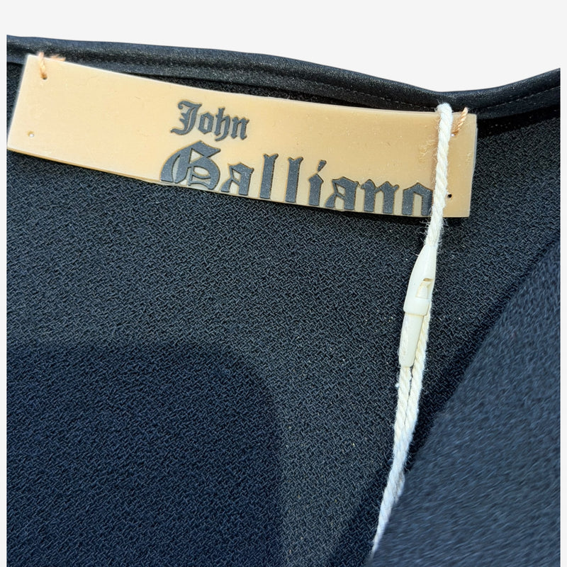 Black wool crepe mini dress by John Galliano, side profile of mini skirt and waist belt