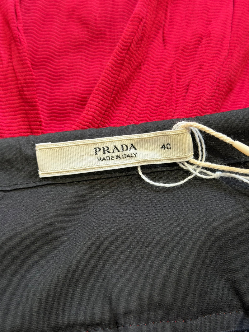 Red crinkled midi skirt by Prada, close-up of crinkled textile surface detail