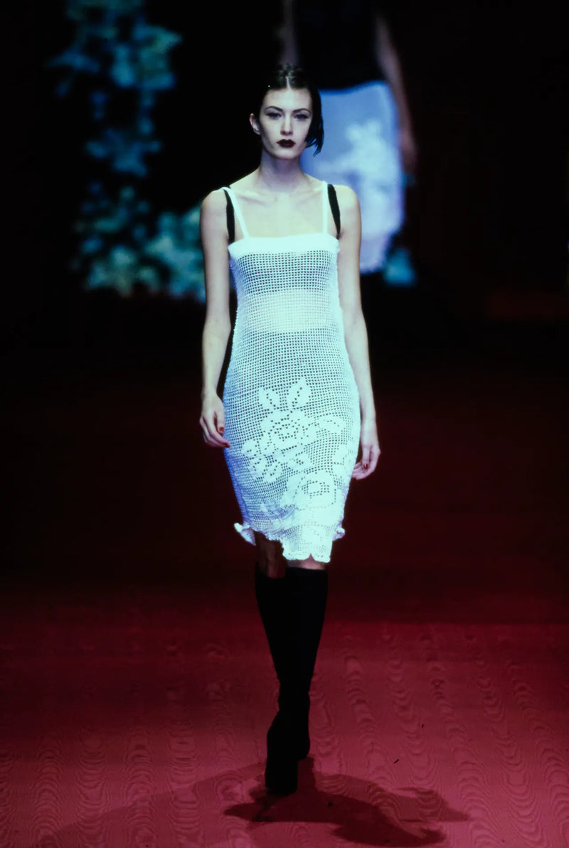 Model wearing black crochet mesh slip dress on Dolce & Gabbana Fall/Winter 1997 runway