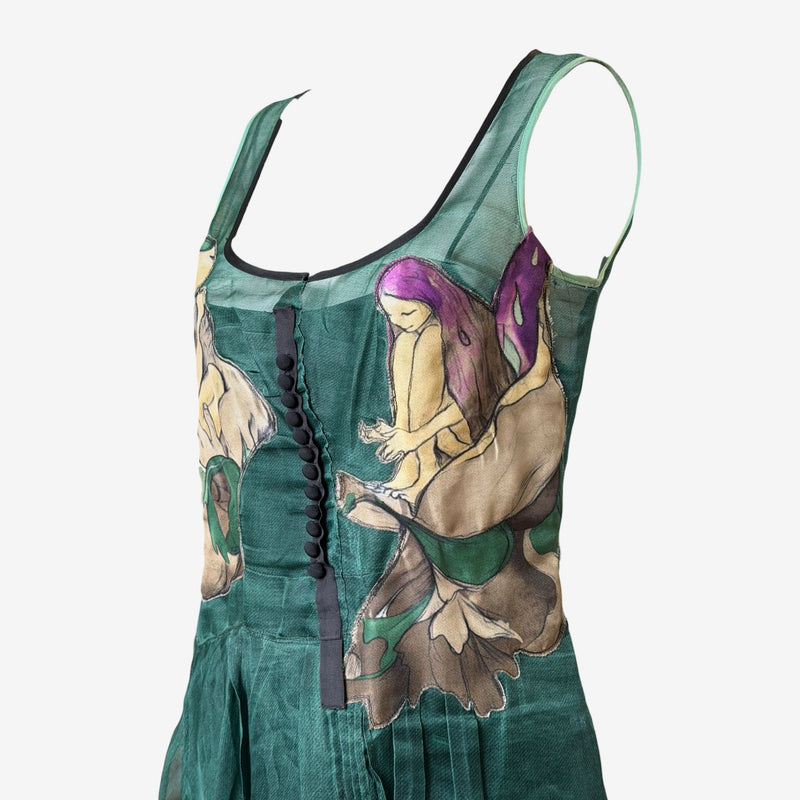 Emerald green silk organza dress by Prada, side profile showing fitted bodice and A-line skirt
