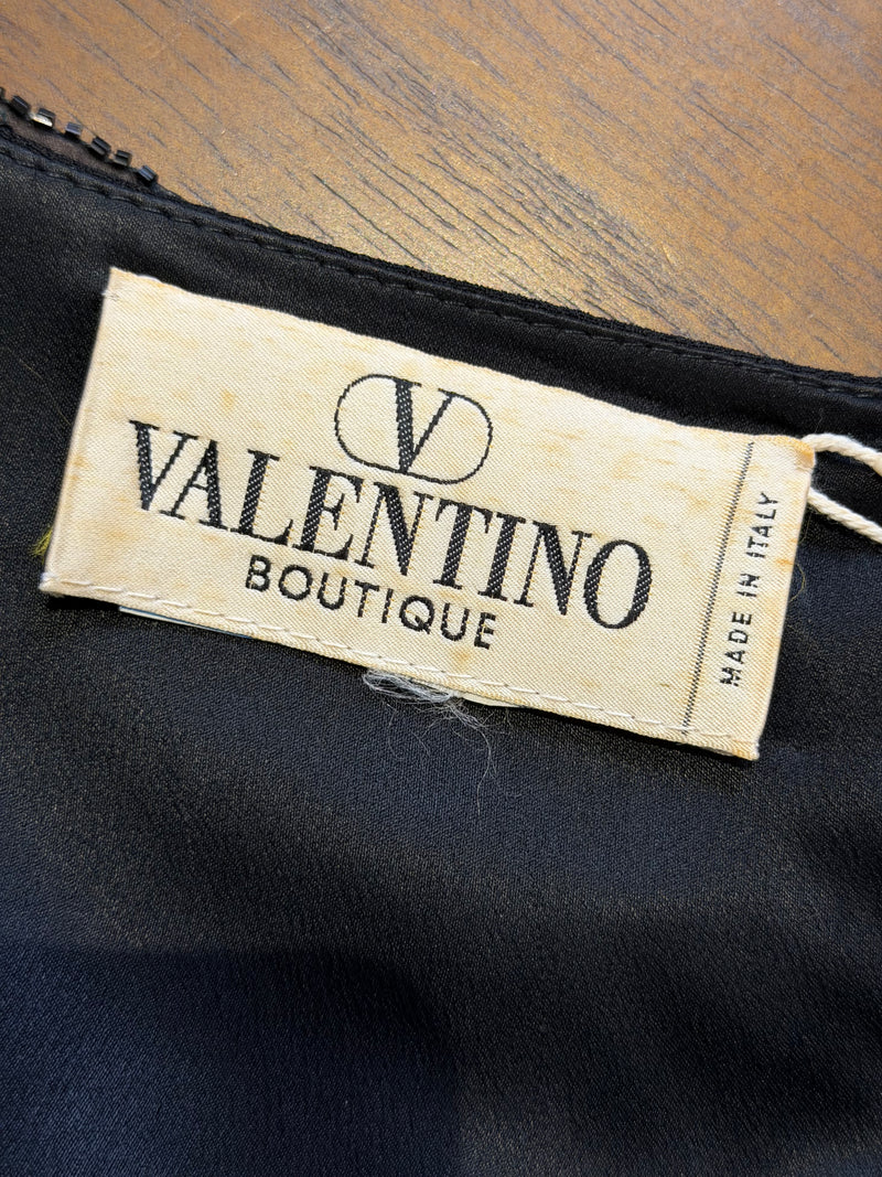 Black beaded evening ensemble by Valentino Boutique, back view of cropped top and skirt