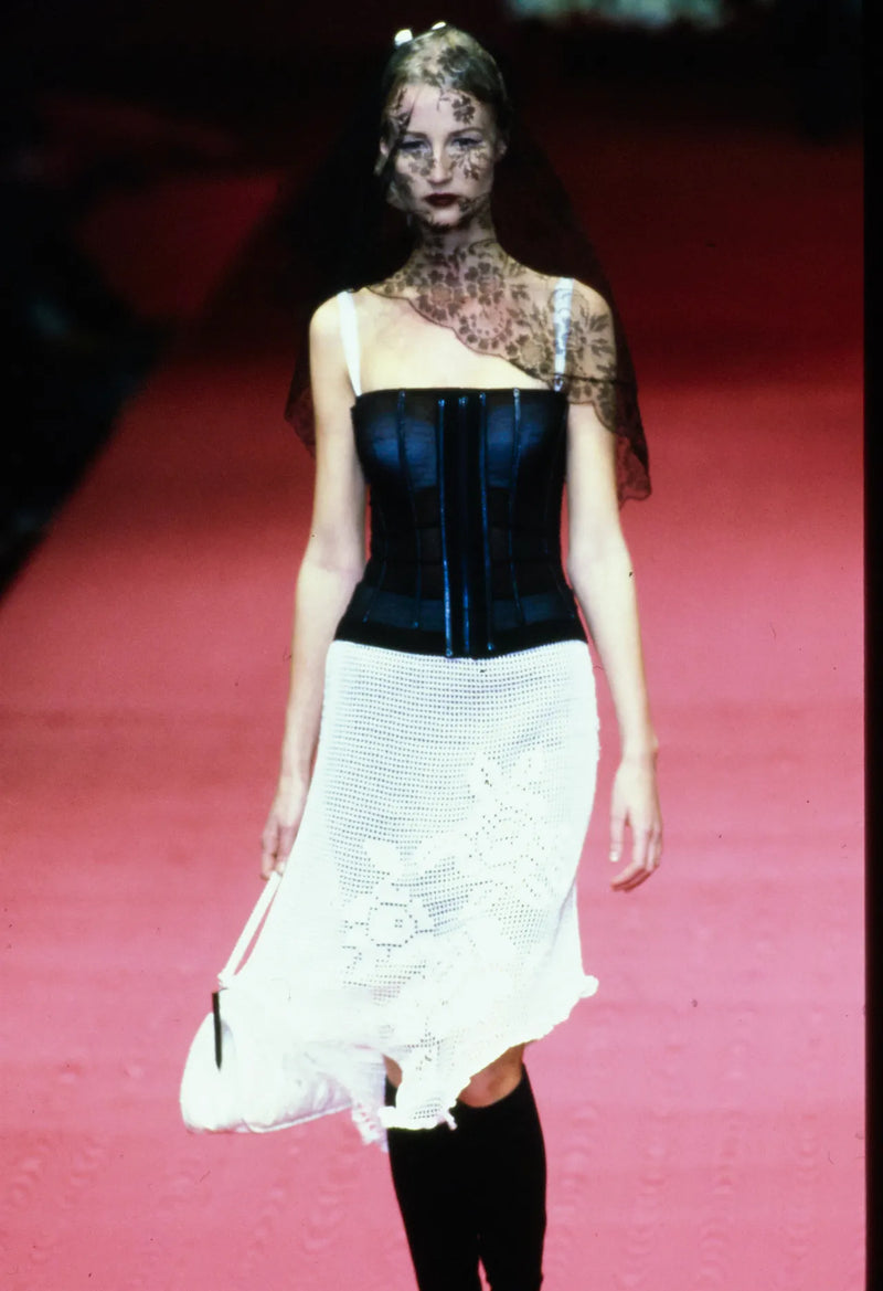Model wearing black crochet mesh slip dress on Dolce & Gabbana Fall/Winter 1997 runway