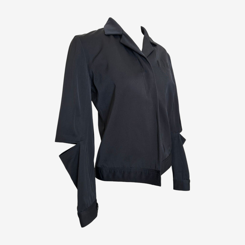 Side view of cream Helmut Lang blazer showing architectural sleeve draping