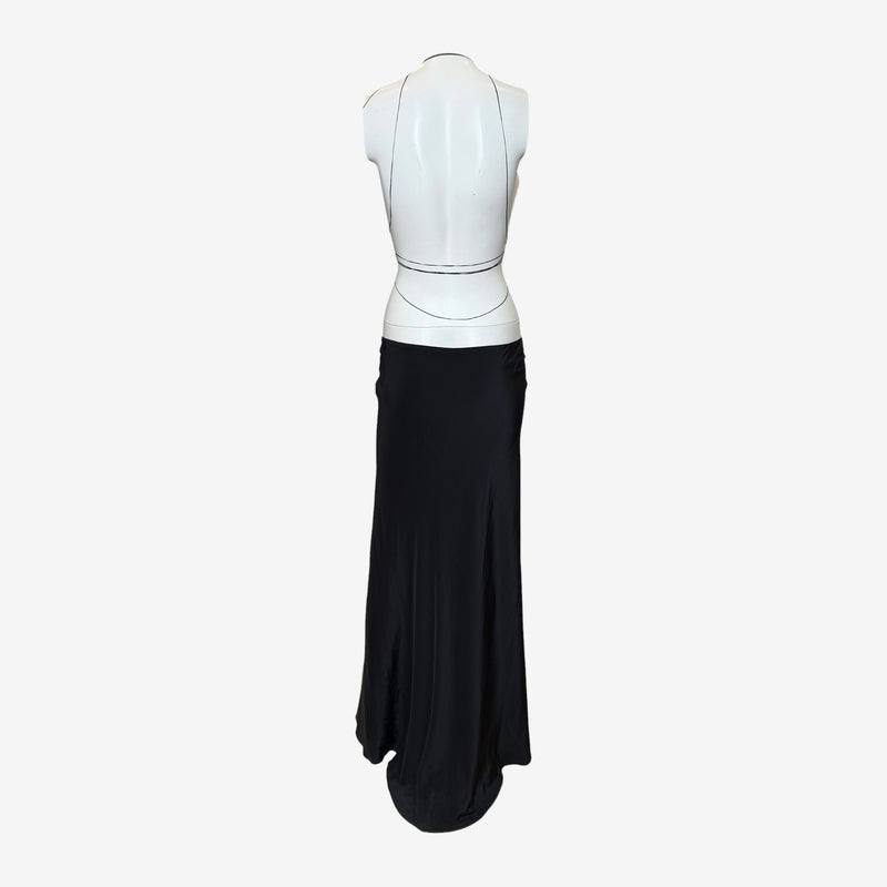 Side profile of black silk column gown showing fluid drape and lace-up panel