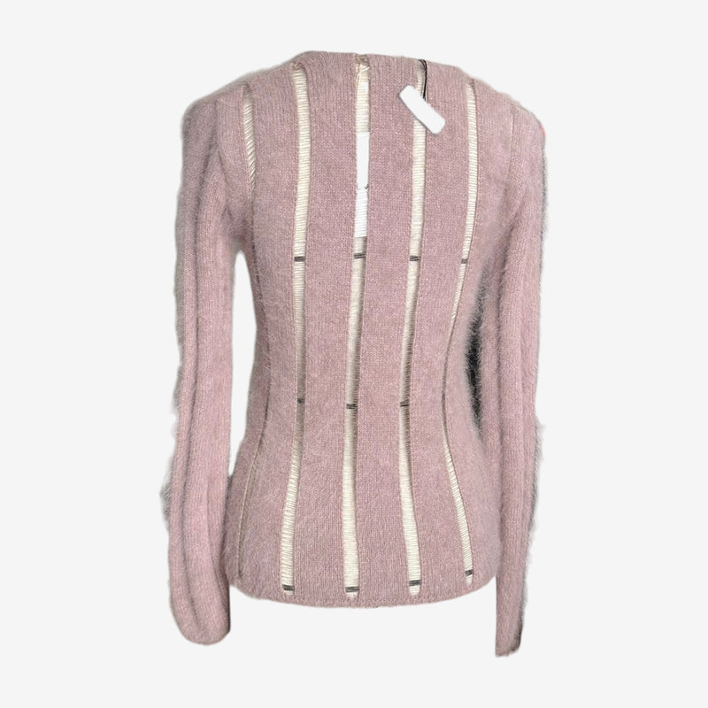 Close-up of corset-inspired hardware securing white ribbon detailing on YSL sweater