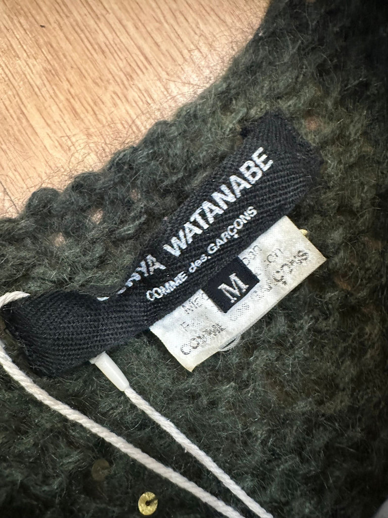 Distressed knit tank by Junya Watanabe, detail of irregular open weave and dangling threads