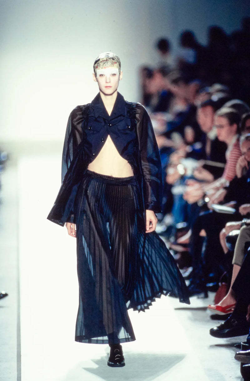 Comme des Garçons S/S 2002 runway look featuring sheer hybrid military jacket with gathered waistband detail