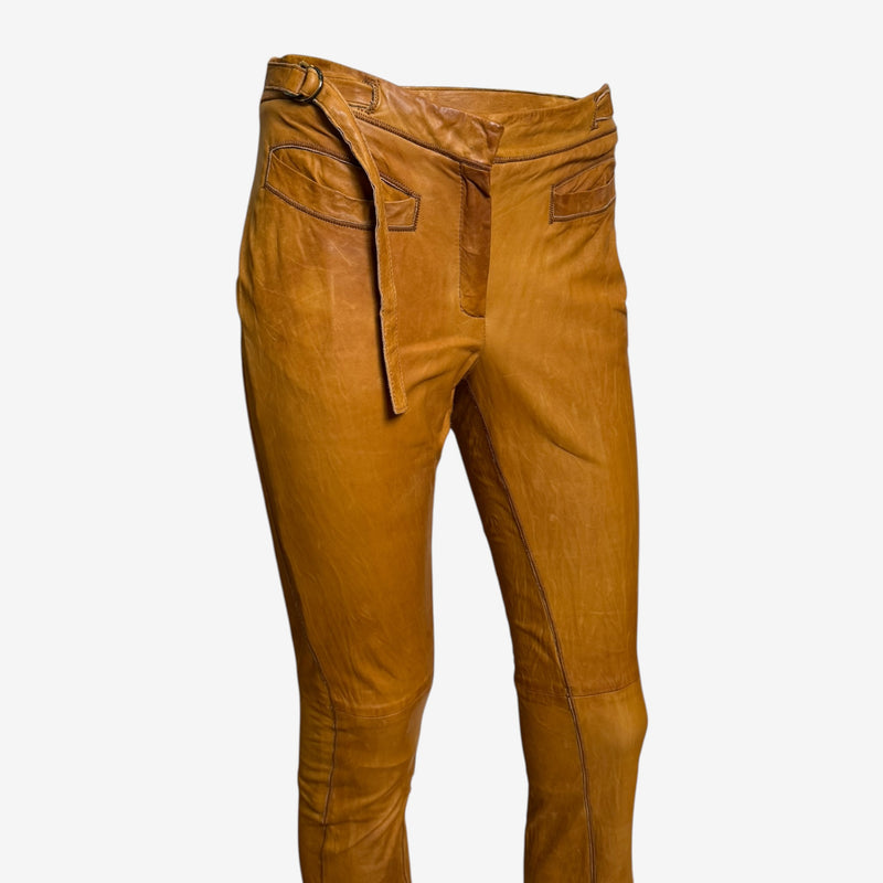 Back pocket detail of cognac leather pants by Roberto Cavalli with tonal tattoo-inspired embroidered design
