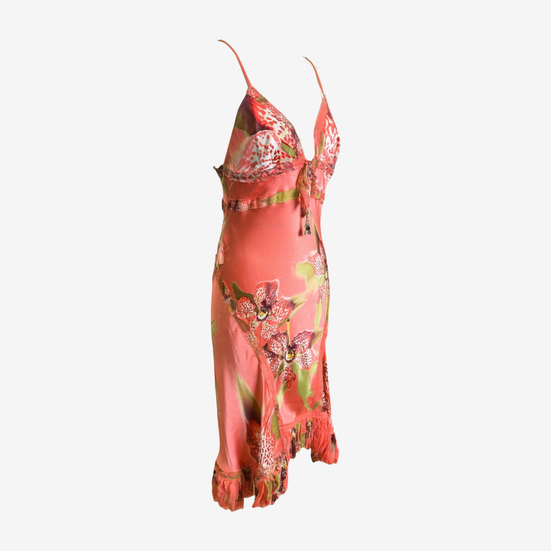Side profile of orchid print silk slip dress by Roberto Cavalli with adjustable straps and tassel detail