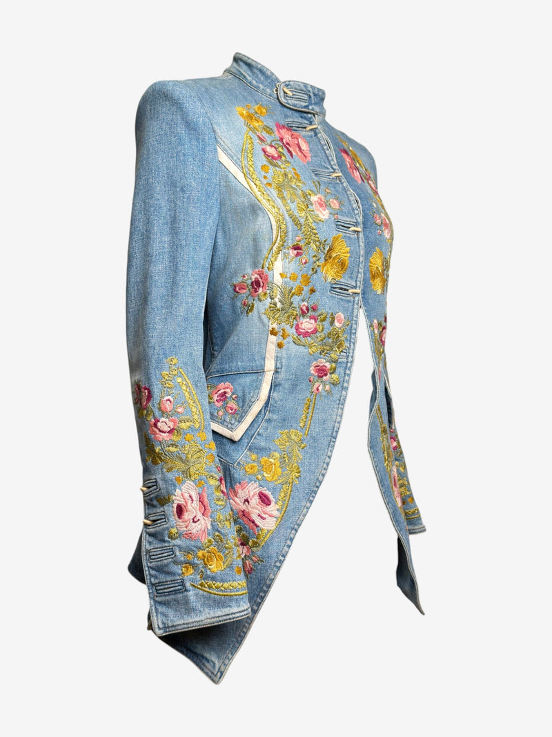 Denim jacket front detail by Roberto Cavalli, showing hand-embroidered scrollwork and white leather piping