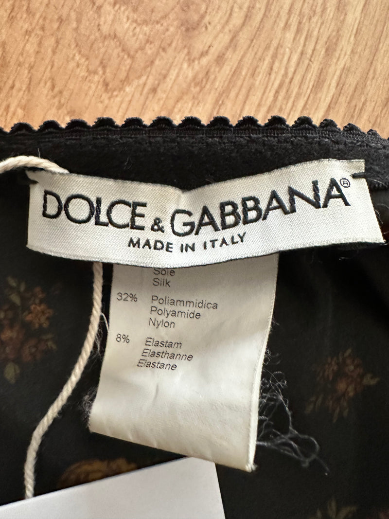 Full length view of black silk pencil skirt by Dolce & Gabbana with floral print, knee-length