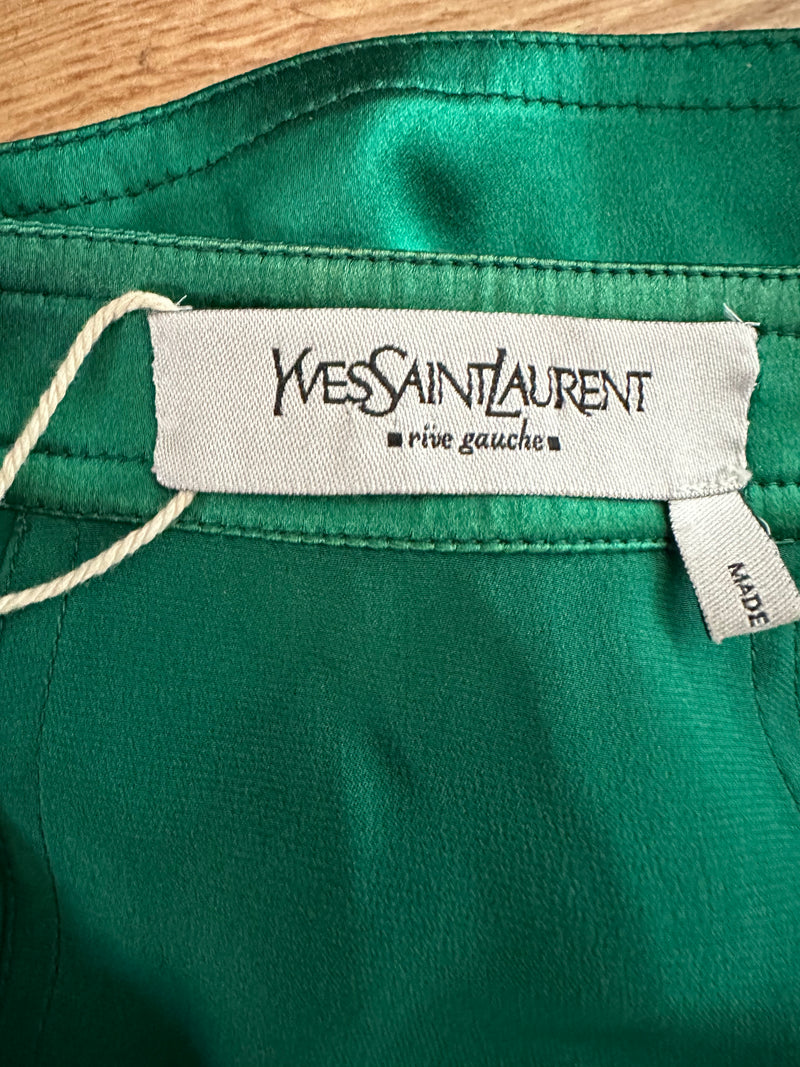 Flat lay of emerald green silk midi skirt with narrow waistband and interior silk lining