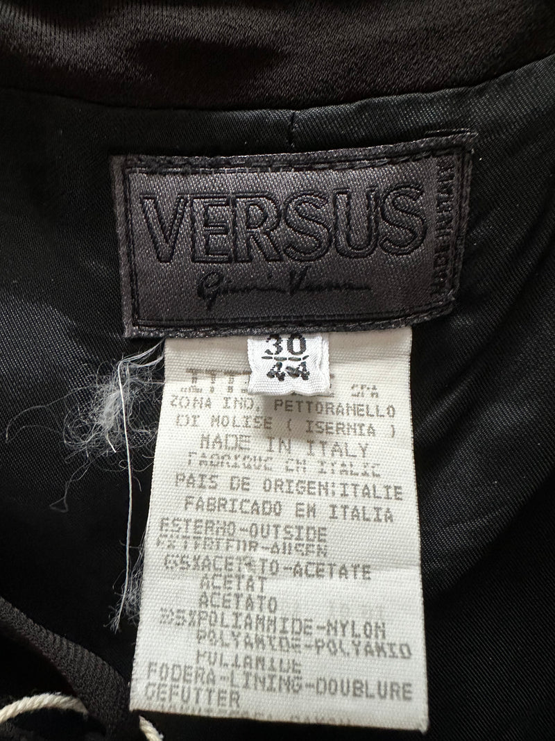 Black Gianni Versace Versus gown, full-length view with asymmetrical neckline fold