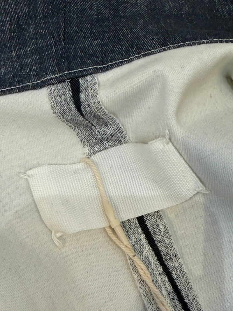 Detail of metal snap closures at shoulders of Margiela cotton vest