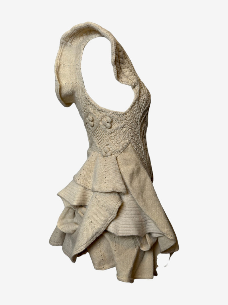 Cream cable knit dress by Tao Comme des Garçons, detail of decorative knit rosettes on bodice