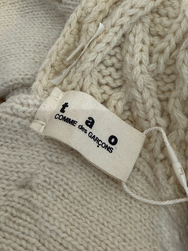 Cream cable knit dress by Tao Comme des Garçons, detail of scoop neckline and sculptural braided patterns