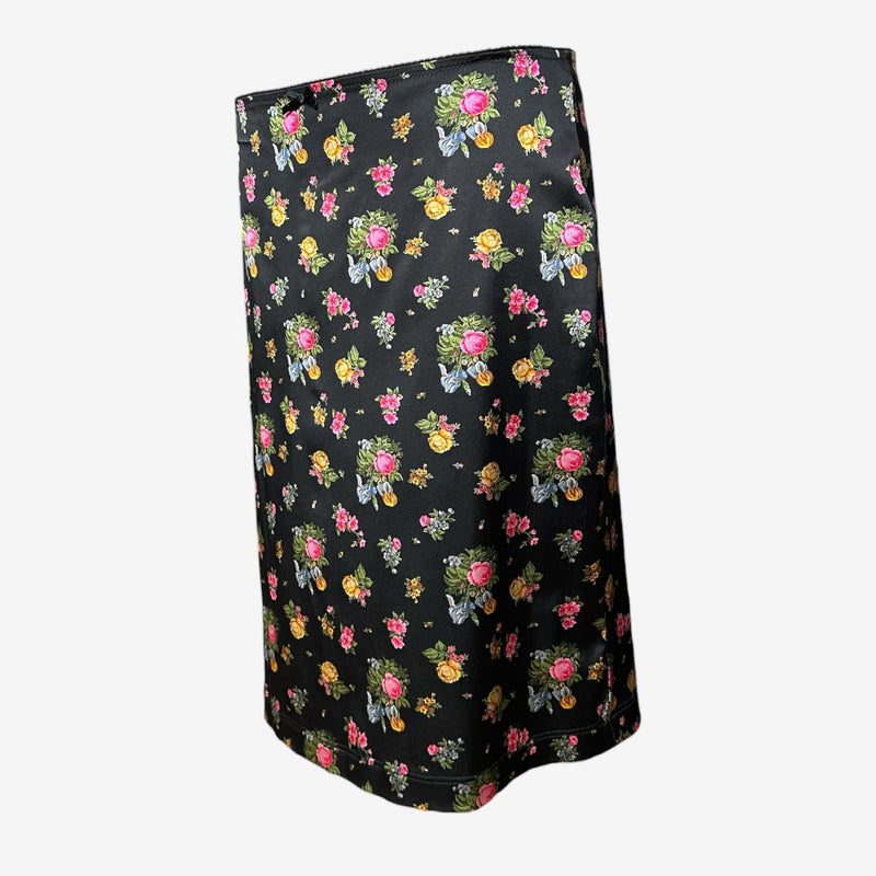 Side view of black silk pencil skirt by Dolce & Gabbana showing fitted silhouette and back vent