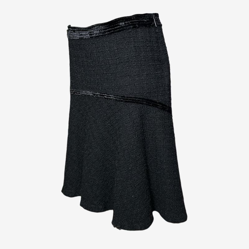 Black wool flare skirt by Roberto Cavalli, side view showing left hip zip closure and deconstructed seaming