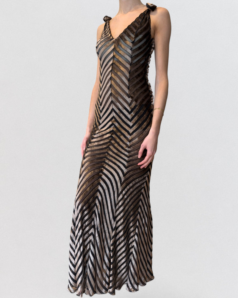 Deep V neckline detail on striped velvet and chiffon gown, fabric-covered buttons along side seam