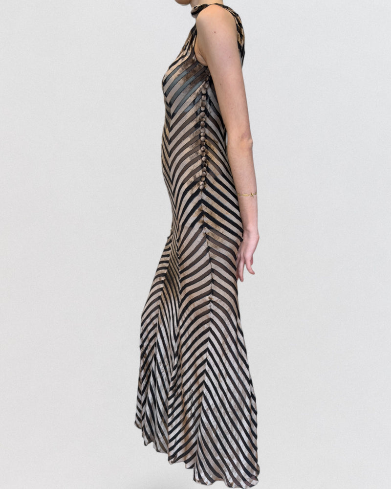 Side profile of striped velvet and chiffon evening gown with chevron panel arrangement