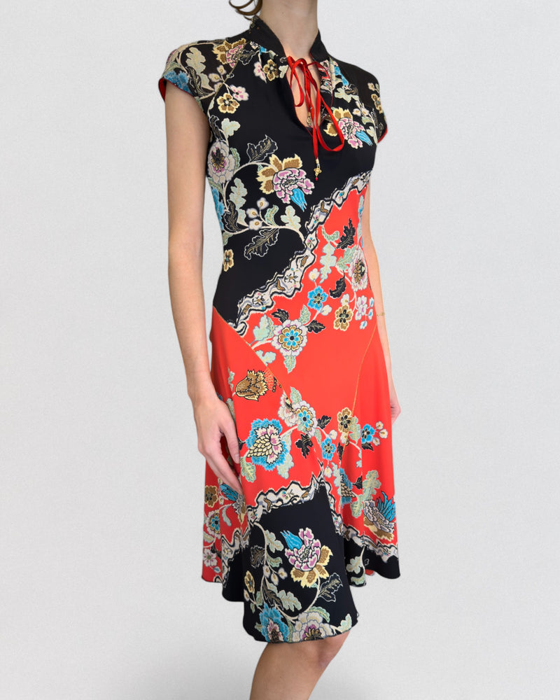 Back view of red and black cheongsam dress by Roberto Cavalli with mandarin collar and flared hem