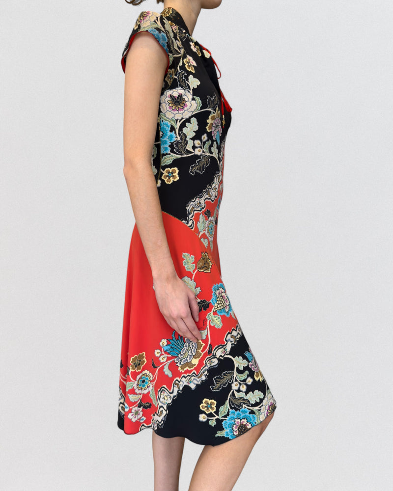 Detail of Roberto Cavalli dress showing intricate dragon and floral print composition on synthetic fabric