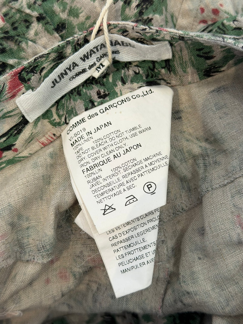 Tropical floral printed parachute skirt showing utilitarian strap construction
