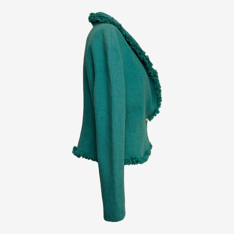 Back view of emerald Dior tweed jacket with fringe detailing along hem