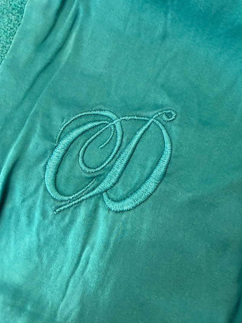 Emerald green Donegal tweed jacket by Christian Dior, three-quarter view showing wrap-style silhouette