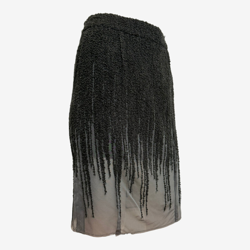 Black wool boucle skirt by Christian Dior, side view showing cascading fringe and semi-sheer underlayer