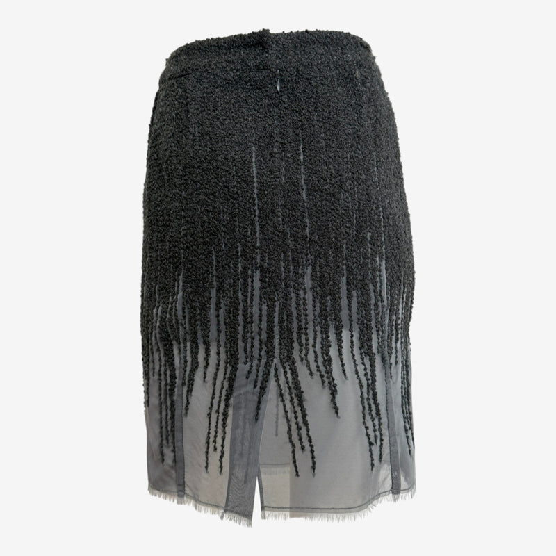 Black wool boucle skirt by Christian Dior, close-up of fringe trim and raw edge chiffon construction