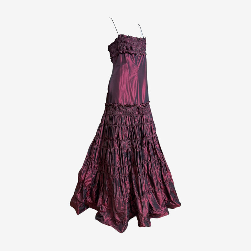 Back view of burgundy gown, detailed smocking and cascading ruffles