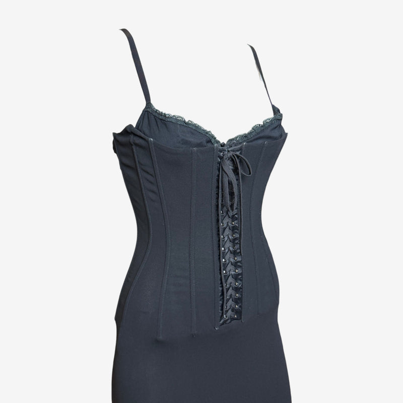Black corset dress detail showing ribbon-threaded lace-up center panel and boned structure