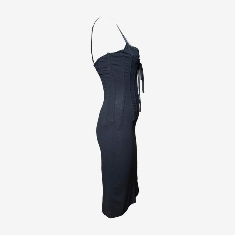 Side detail of black corset dress showing structured boning and fitted silhouette