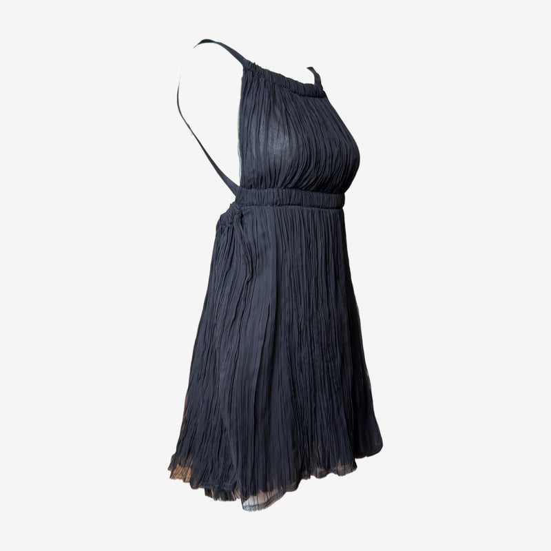 Charcoal black pleated silk mini dress by Fendi, side profile showing blouson silhouette and narrow straps