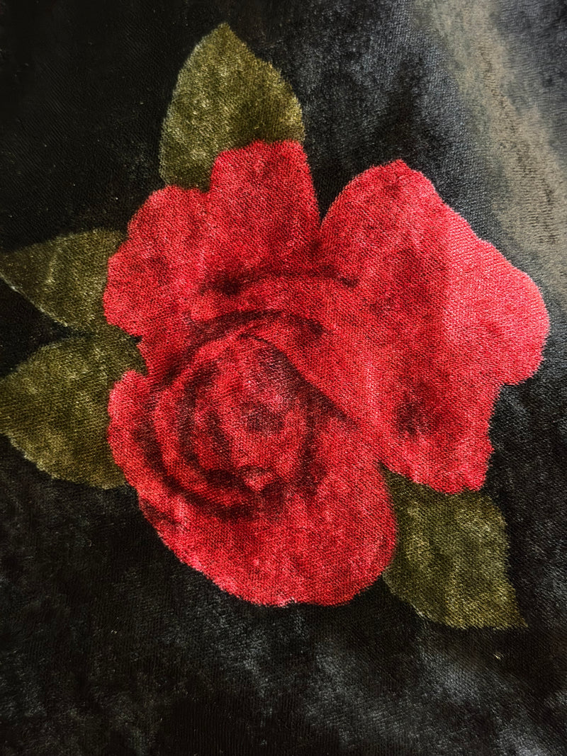 Close-up of black velvet with scattered red rose appliqués on Dolce & Gabbana slip gown
