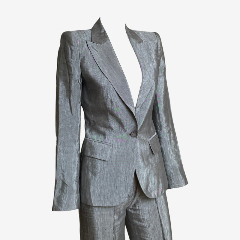 Grey iridescent wool suit detail showing McQueen engraved silver-tone button and notched lapel