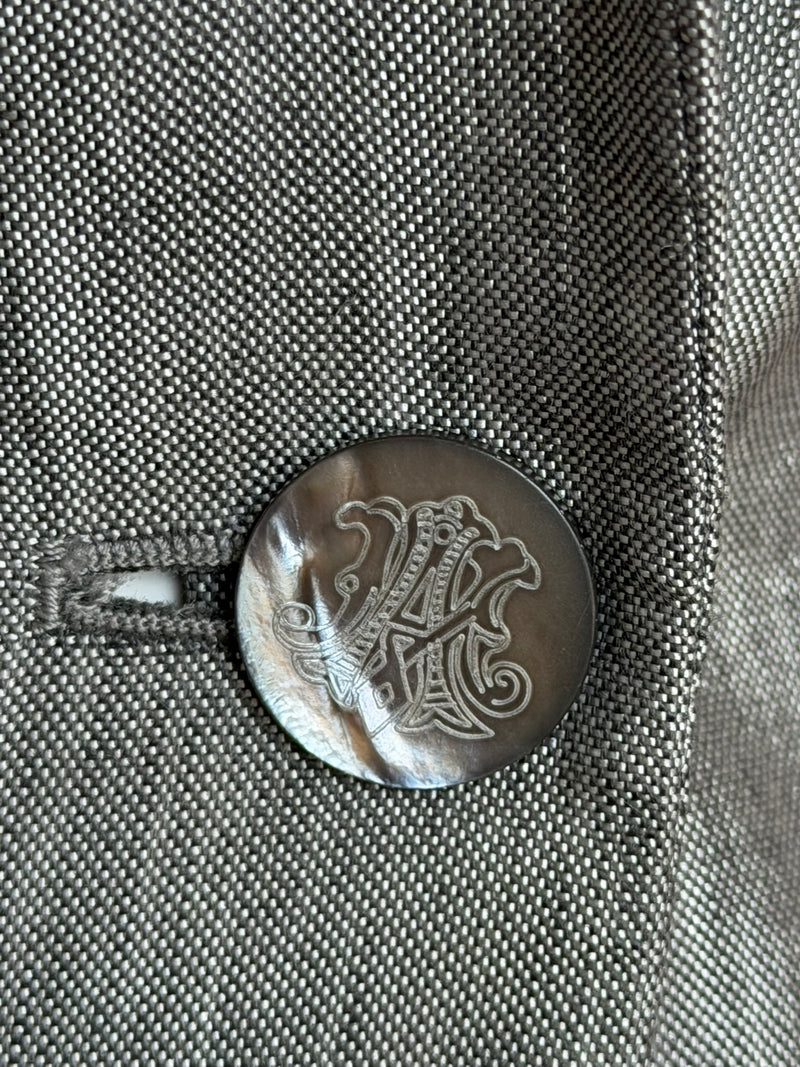 Grey iridescent wool suit by Alexander McQueen, detail of jacket sleeve and shoulder construction