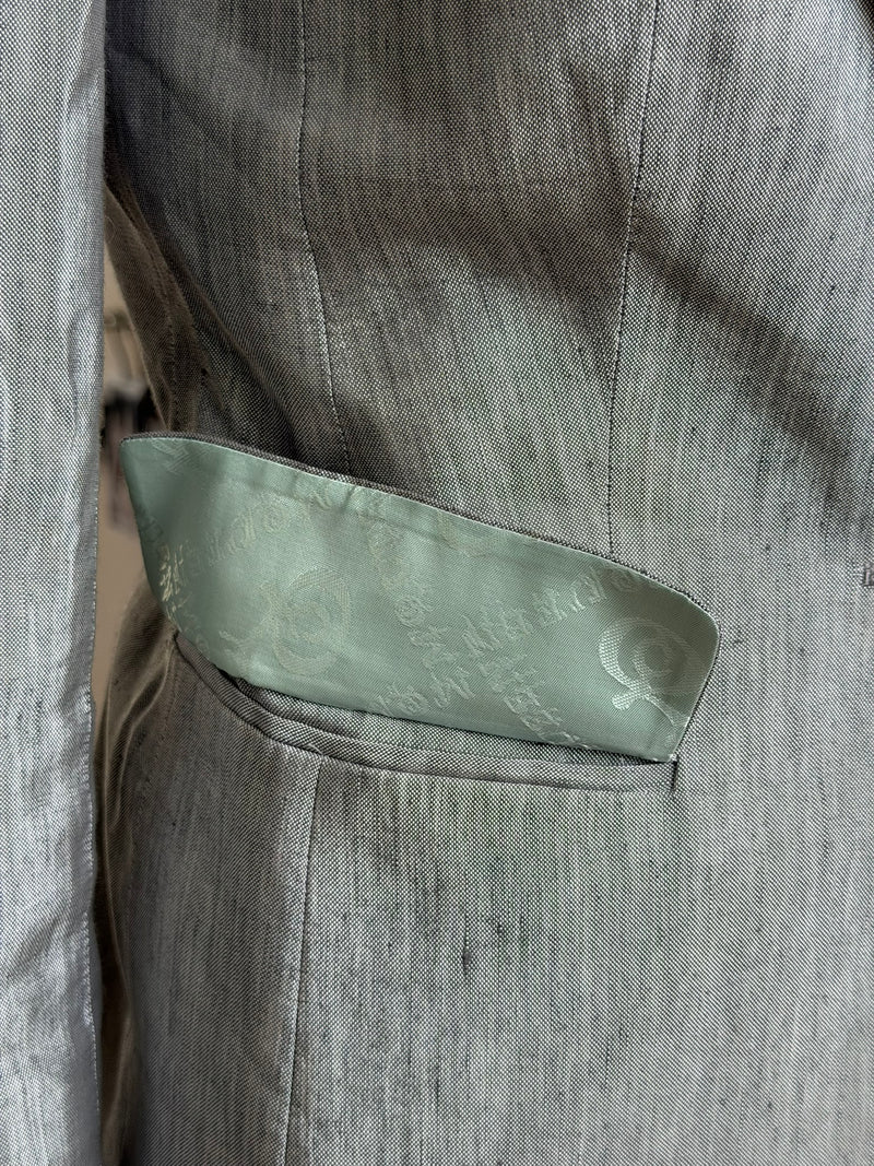 Alexander McQueen grey wool suit jacket, showing iridescent quality and rainbow undertones in light