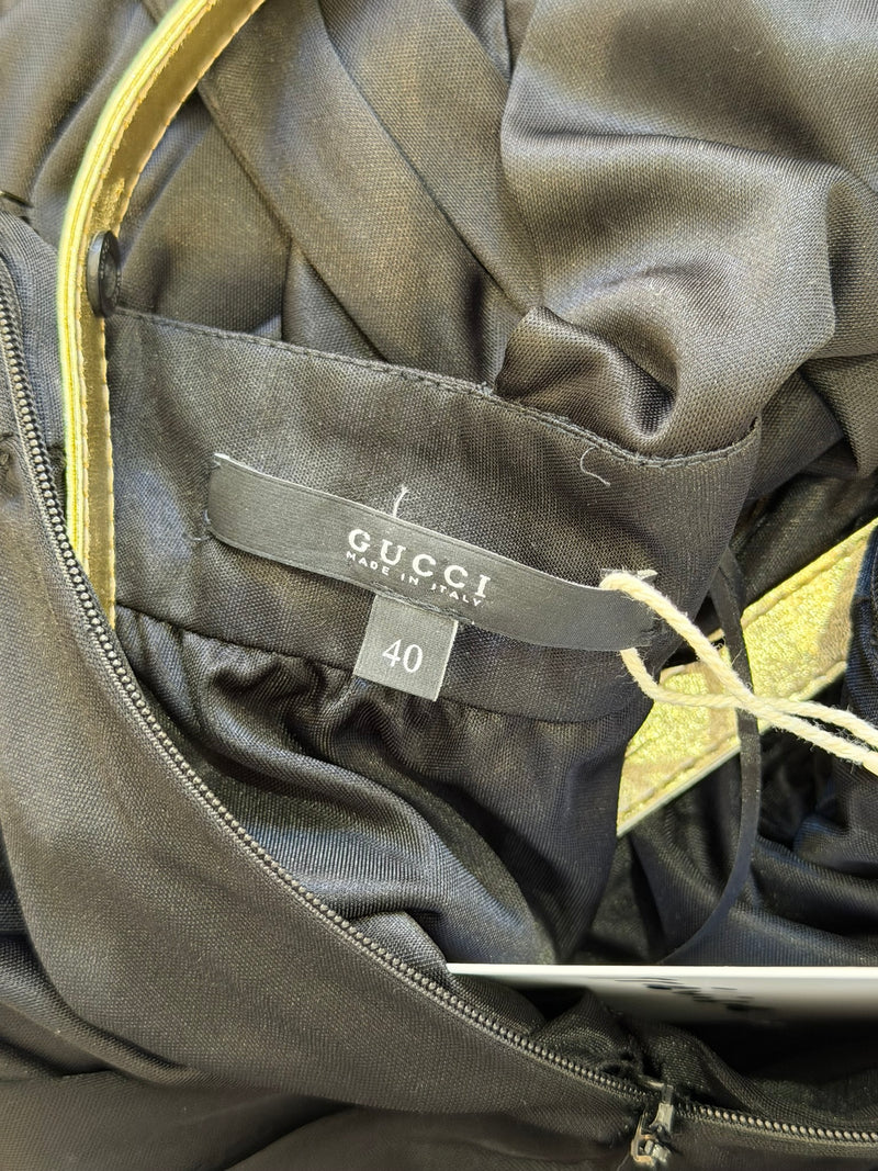 Black jersey halter gown by Gucci, detail of gold-toned hardware at neckline
