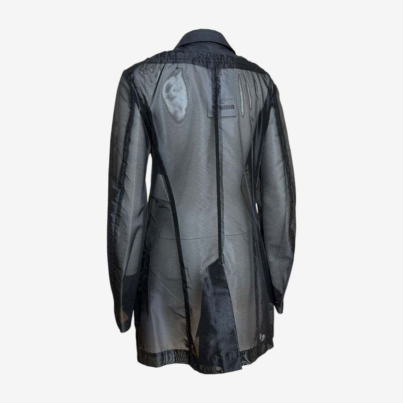 Sheer sleeve detail on Comme des Garçons hybrid military jacket, revealing layering effect