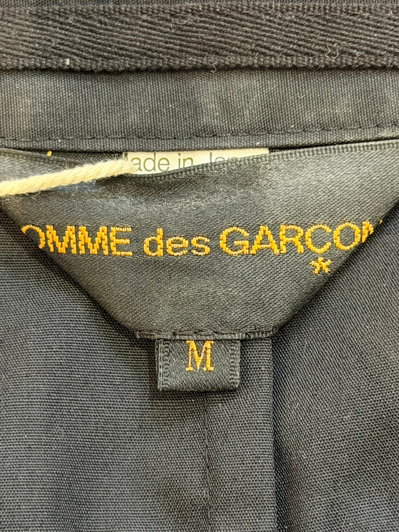 Navy gabardine military jacket by Comme des Garçons, chest flap pocket with button closure detail