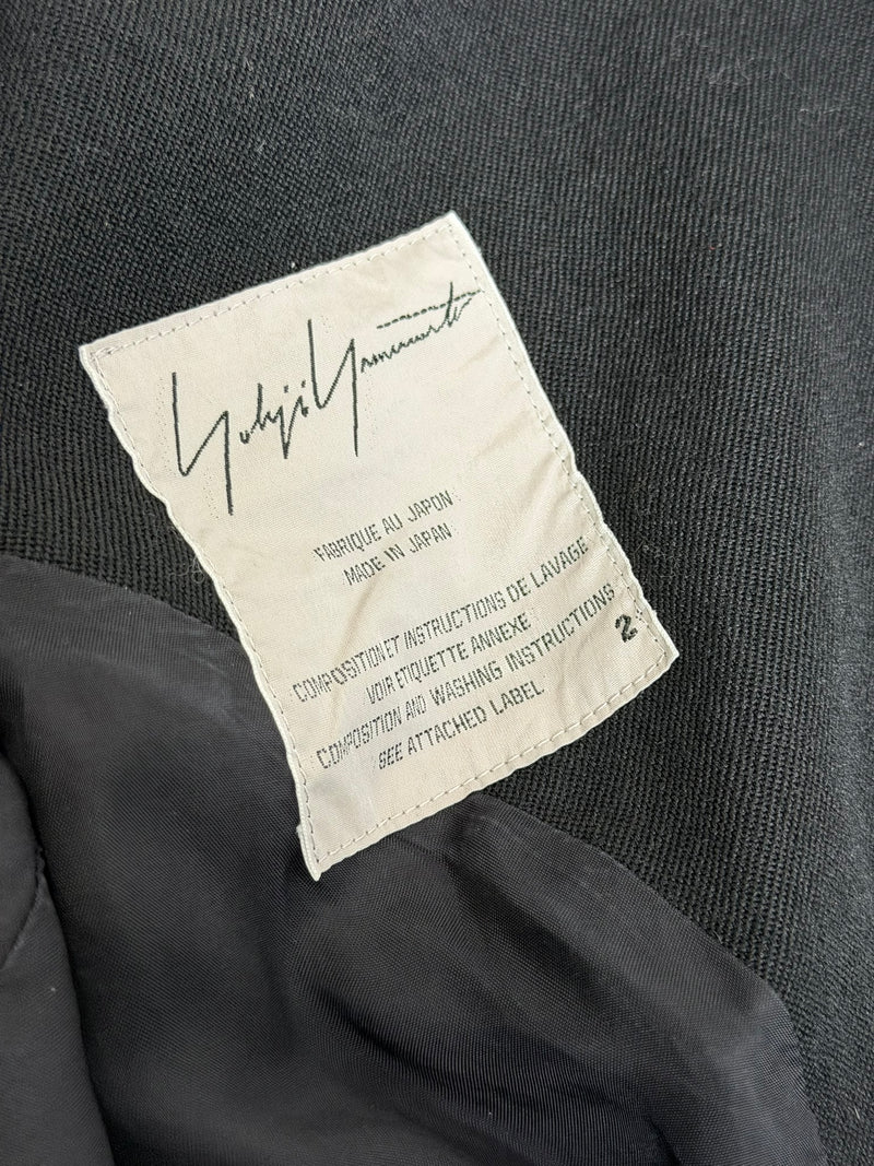 Black wool jacket by Yohji Yamamoto, detail of double-breasted glossy buttons