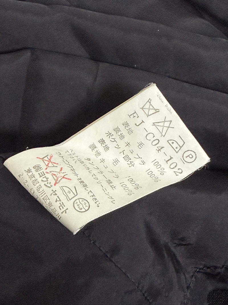 Black wool jacket by Yohji Yamamoto, back view showing wrapped construction