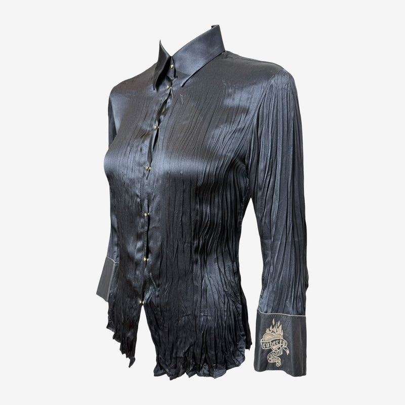 Cream Roberto Cavalli silk shirt, close-up of leather cuff with sacred heart embroidery and banner detail