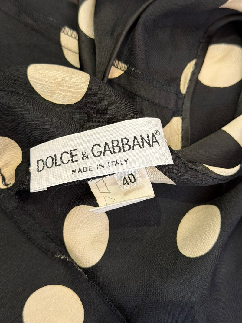Deep V-neckline detail of black and cream polka dot Dolce & Gabbana mini dress