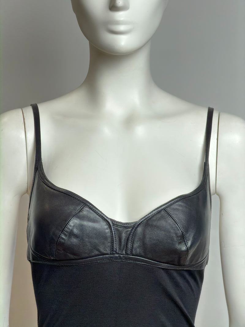 Black draped leather-cup dress by Alexander McQueen, side profile showing asymmetrical silhouette